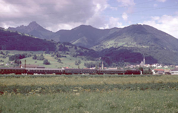train rolls through the countryside