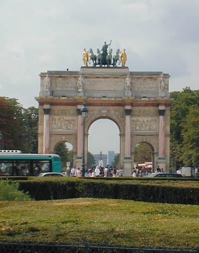 the arc de triomphe and the place de la concorde obelisk seen through the arc du carrousel at the louvre