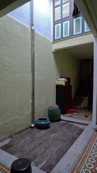 inside a converted shophouse, with interior open to the sky